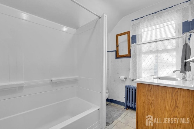 186 Brahma Ave, Bridgewater, NJ 08807 - full bathroom with radiator heating unit, tile walls, toilet, shower / tub combination, and vanity