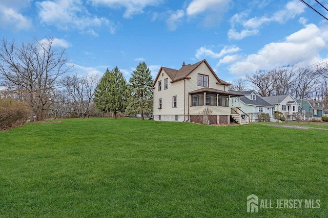 186 Brahma Ave, Bridgewater, NJ 08807 - view of property exterior featuring a sunroom, a lawn, and a chimney