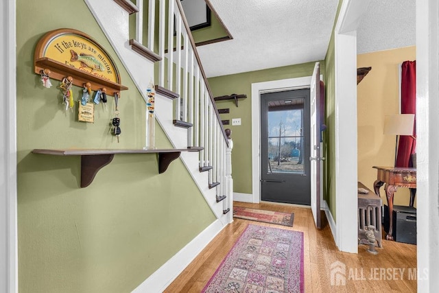 186 Brahma Ave, Bridgewater, NJ 08807 - foyer entrance with stairway, wood finished floors, a textured ceiling, and baseboards