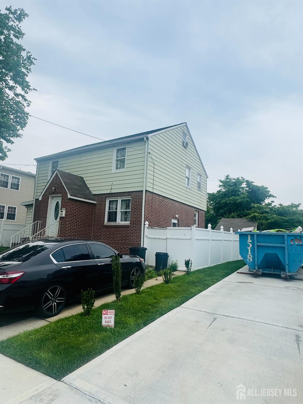 52 Hermann Ave, Carteret, NJ 07008 - view of side of home featuring brick siding and concrete driveway
