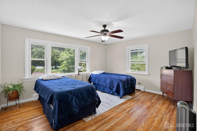 858 Burnt Tavern Rd, Brick, NJ 08724 - bedroom featuring light wood-style floors, ceiling fan, and a baseboard heating unit