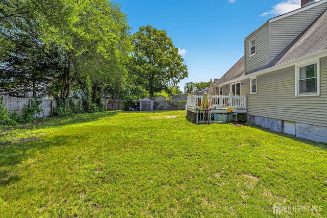 858 Burnt Tavern Rd, Brick, NJ 08724 - fenced backyard with a storage unit and a wooden deck
