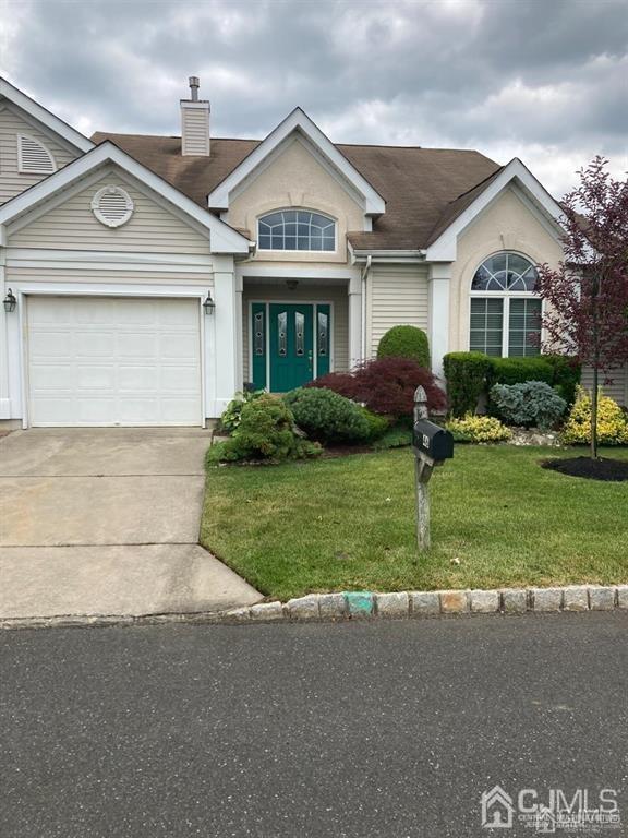 46 Chichester Rd, Monroe, NJ 08831 - view of front of home featuring concrete driveway, a front yard, an attached garage, and a chimney