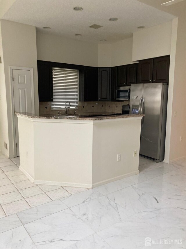 46 Chichester Rd, Monroe, NJ 08831 - kitchen with stainless steel appliances, light marble finish floors, a sink, baseboards, and backsplash