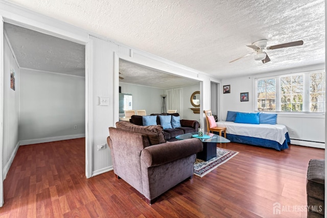 39 Webb Dr, Fords, NJ 08863 - living room featuring a textured ceiling, wood finished floors, ceiling fan, a baseboard radiator, and crown molding