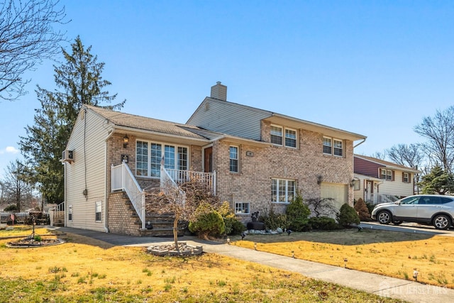 39 Webb Dr, Fords, NJ 08863 - view of front of house with a chimney, brick siding, an attached garage, and stairs