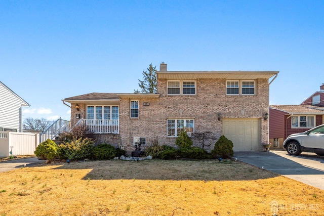 39 Webb Dr, Fords, NJ 08863 - tri-level home with brick siding, a garage, driveway, a chimney, and a front lawn