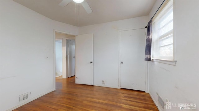 unfurnished bedroom featuring ceiling fan and hardwood / wood-style floors