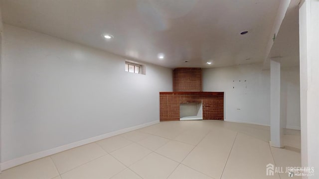 unfurnished living room with light tile patterned floors and a fireplace