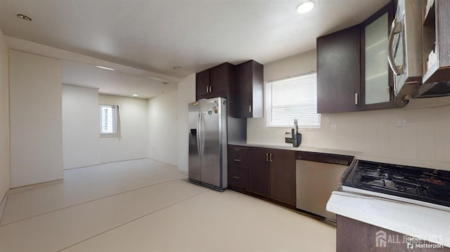 kitchen with a healthy amount of sunlight, stainless steel appliances, and dark brown cabinets