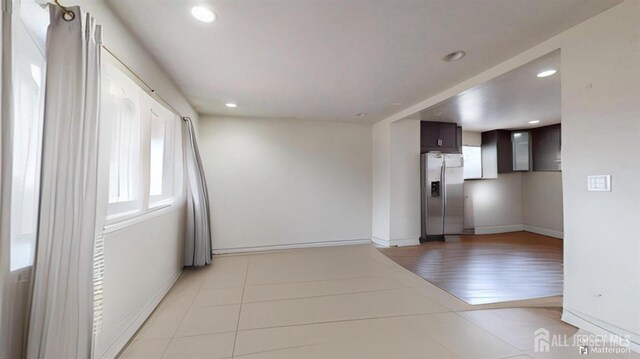 spare room with light tile patterned floors