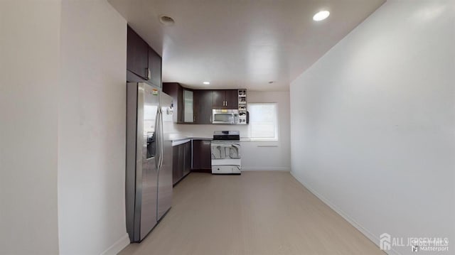 kitchen featuring appliances with stainless steel finishes and dark brown cabinets