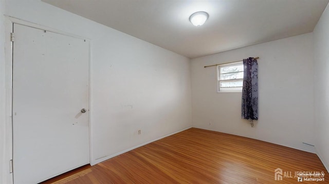 unfurnished room featuring hardwood / wood-style floors