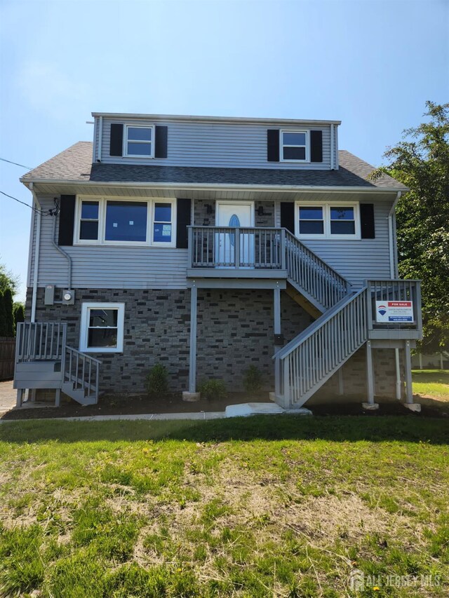 212 Huff Ave, Manville, NJ 08835 - view of front of property featuring stairway, a front yard, stone siding, and roof with shingles