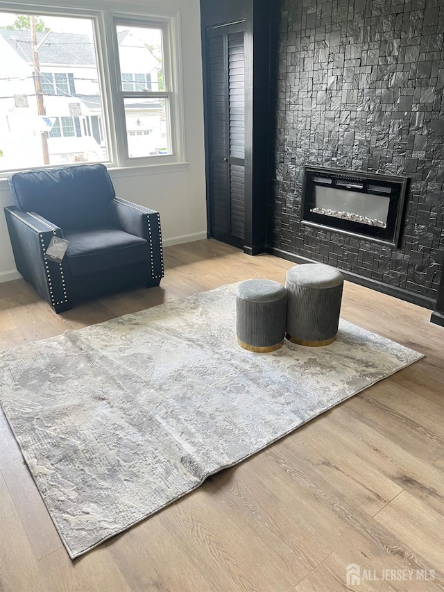 212 Huff Ave, Manville, NJ 08835 - sitting room with a glass covered fireplace, baseboards, and wood finished floors