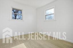 212 Huff Ave, Manville, NJ 08835 - unfurnished room with baseboards and wood finished floors
