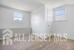 212 Huff Ave, Manville, NJ 08835 - spare room featuring wood finished floors