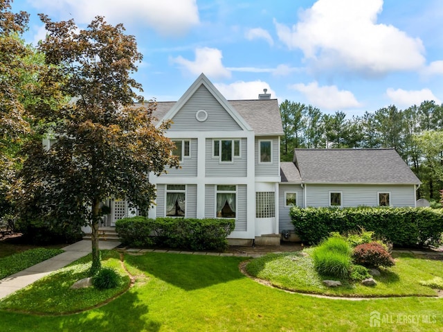 10 Jason Dr, East Brunswick, NJ 08816 - view of front of home featuring a front lawn, a chimney, and a shingled roof