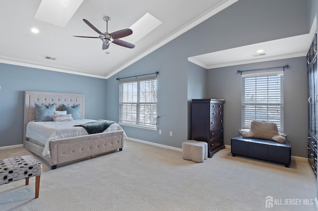 carpeted bedroom with baseboards, vaulted ceiling with skylight, visible vents, and ornamental molding