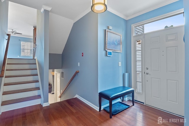 entryway featuring visible vents, baseboards, stairway, ornamental molding, and wood-type flooring