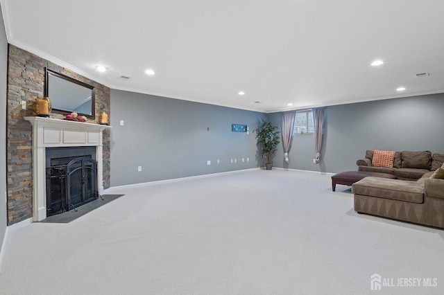 living area featuring visible vents, baseboards, carpet floors, a fireplace, and ornamental molding