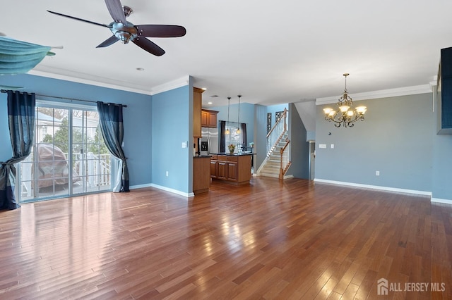 unfurnished living room with stairs, dark wood finished floors, baseboards, and ornamental molding