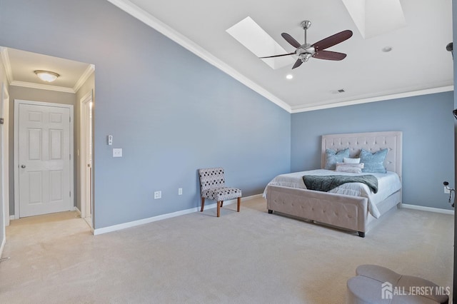 bedroom with visible vents, crown molding, baseboards, lofted ceiling with skylight, and light carpet