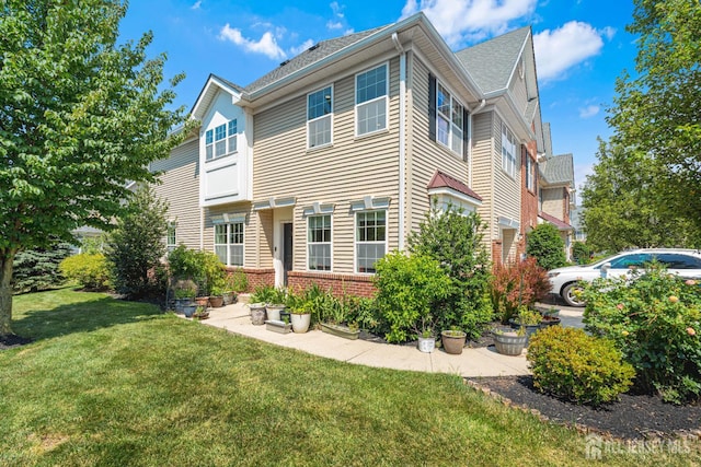 36 Andrews Way, Piscataway, NJ 08854 - view of front facade featuring a front yard and brick siding