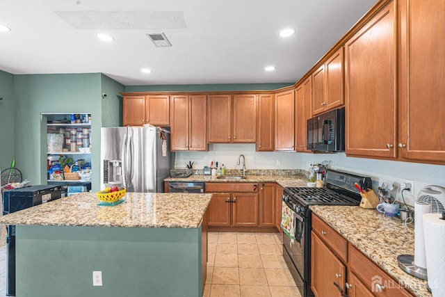 36 Andrews Way, Piscataway, NJ 08854 - kitchen featuring black appliances, light stone countertops, brown cabinetry, recessed lighting, and a center island