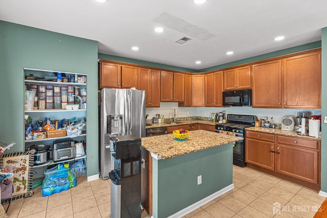 36 Andrews Way, Piscataway, NJ 08854 - kitchen with black appliances, light stone counters, light tile patterned floors, a center island, and brown cabinets