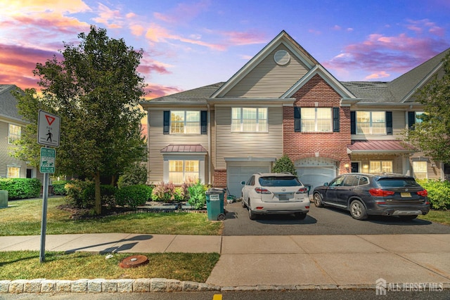 36 Andrews Way, Piscataway, NJ 08854 - view of front of home featuring driveway, a garage, and brick siding