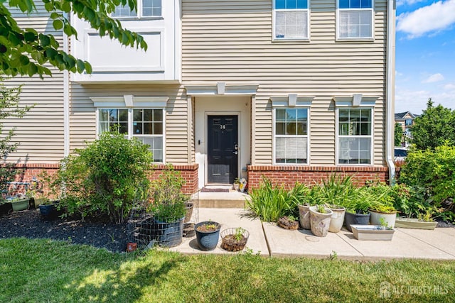 36 Andrews Way, Piscataway, NJ 08854 - doorway to property with brick siding and a lawn