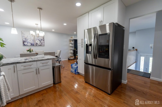 128 Jay St, Middlesex, NJ 08846 - kitchen featuring stainless steel fridge with ice dispenser, a chandelier, white cabinets, light wood finished floors, and recessed lighting