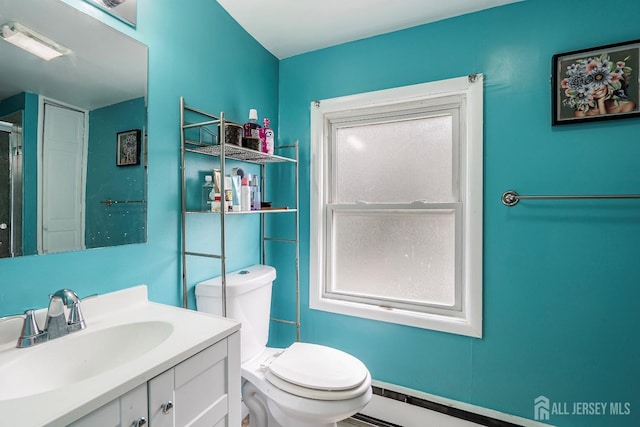 bathroom with vanity, a baseboard radiator, and toilet