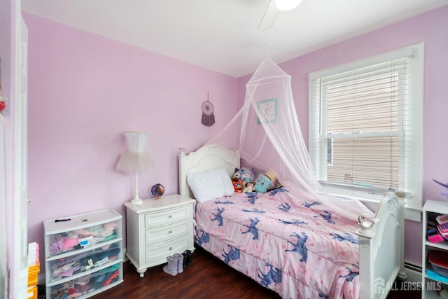 bedroom with ceiling fan and dark wood-type flooring