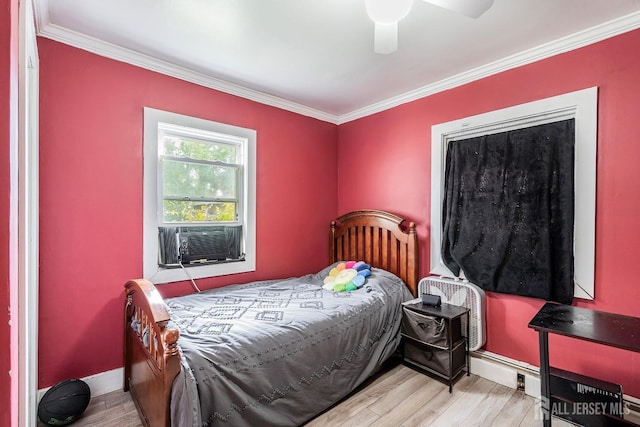 bedroom with cooling unit, light hardwood / wood-style floors, ceiling fan, and ornamental molding