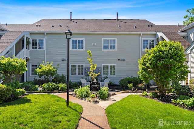 40 Rutland Ln Unit 40C, Monroe, NJ 08831 - back of house with a lawn, roof with shingles, and a patio area