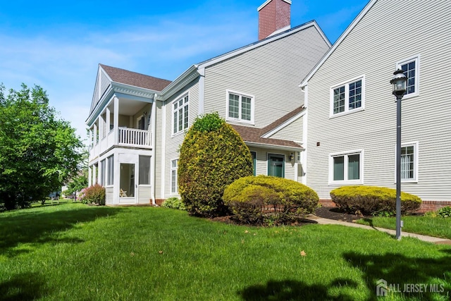 40 Rutland Ln Unit 40C, Monroe, NJ 08831 - rear view of property with a chimney, a yard, and roof with shingles