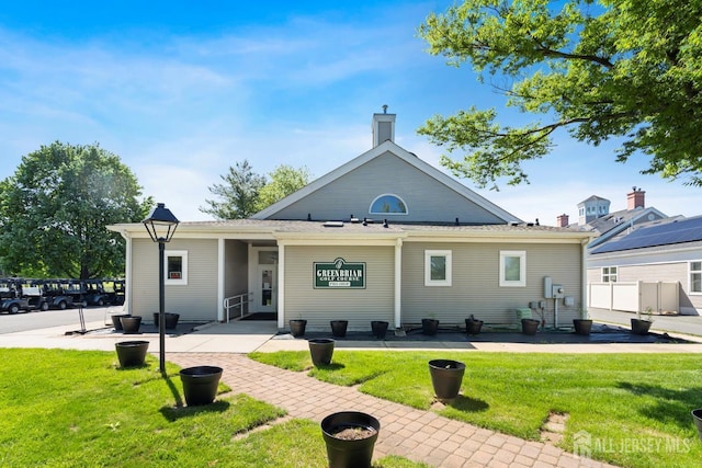 40 Rutland Ln Unit 40C, Monroe, NJ 08831 - rear view of house with a yard and a chimney