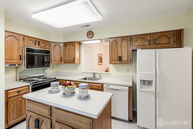 40 Rutland Ln Unit 40C, Monroe, NJ 08831 - kitchen with white appliances, a sink, light countertops, and brown cabinetry