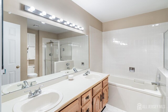 40 Rutland Ln Unit 40C, Monroe, NJ 08831 - full bath with toilet, a garden tub, a shower with shower door, double vanity, and tile patterned floors