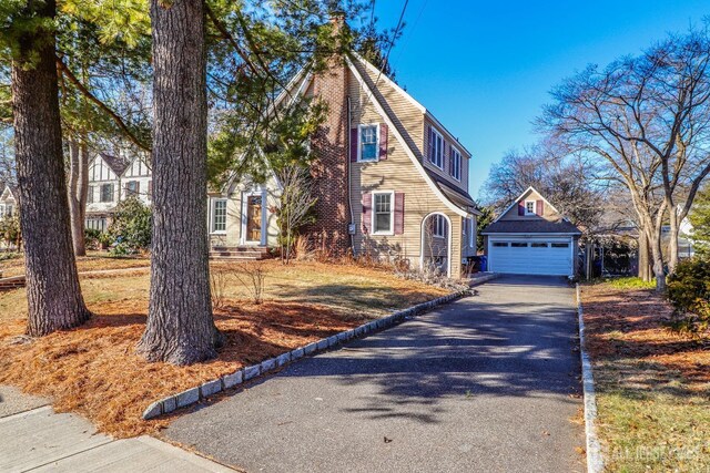 view of front of house featuring a garage and an outdoor structure