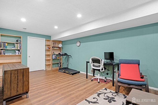 office with recessed lighting and wood finished floors