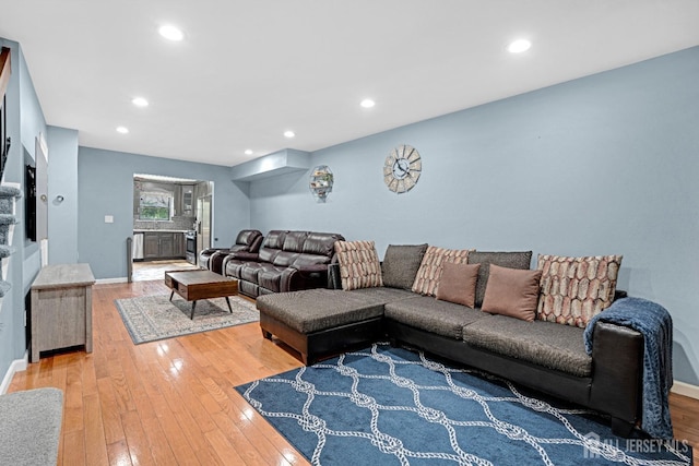 living area with recessed lighting, baseboards, and light wood-style floors