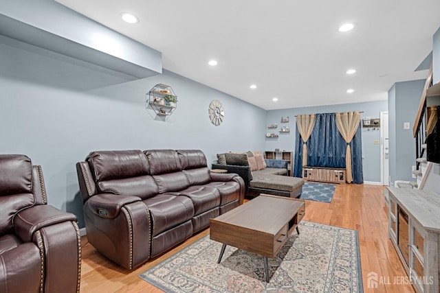 living room with stairs, light wood-style floors, and recessed lighting
