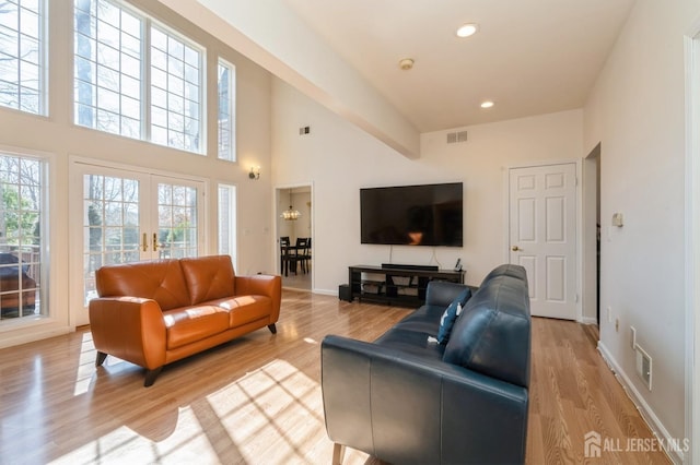 living room with a healthy amount of sunlight, visible vents, and light wood-type flooring