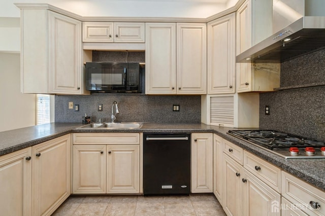 kitchen featuring black appliances, a sink, cream cabinets, wall chimney range hood, and decorative backsplash