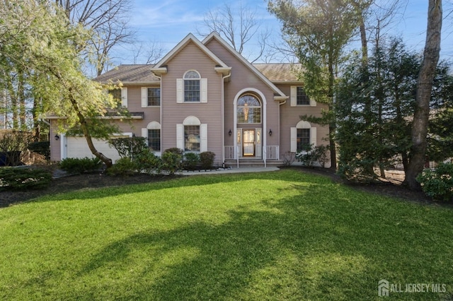 view of front facade with an attached garage and a front yard