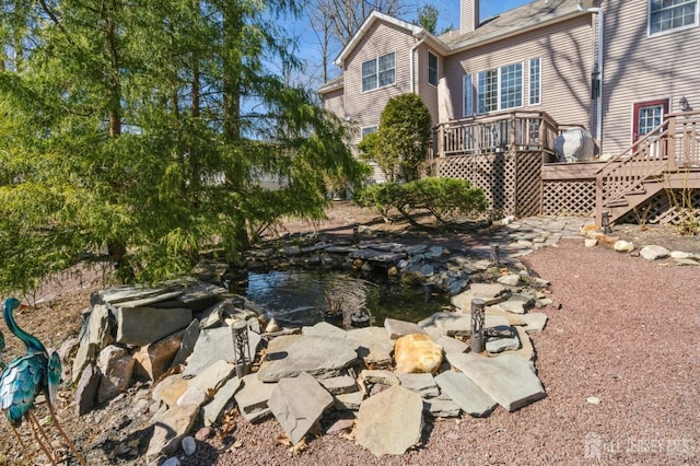 view of yard with a garden pond and a wooden deck