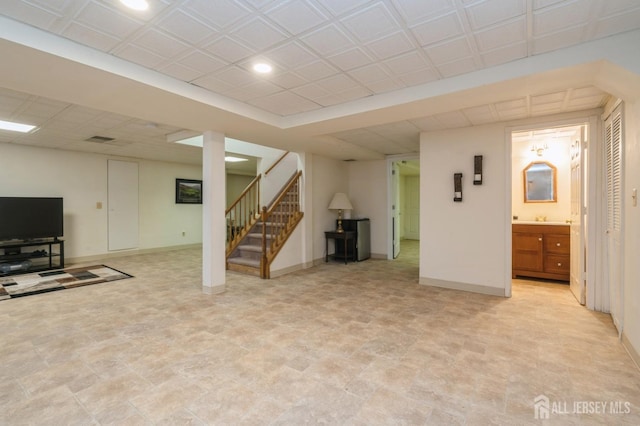 finished below grade area featuring stairway, recessed lighting, and baseboards